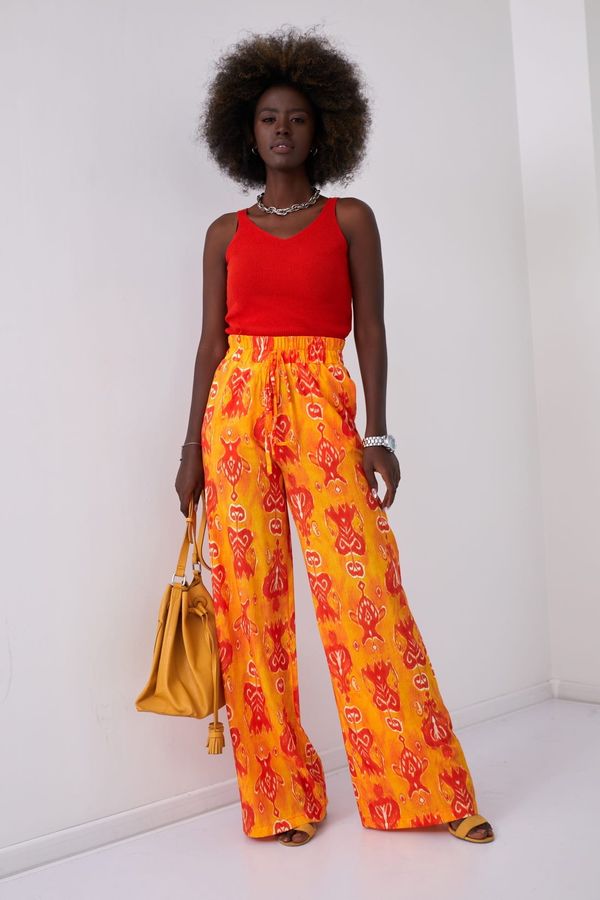FASARDI Wide women's trousers with orange patterns