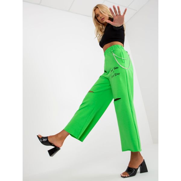 Fashionhunters Light green wide sweatpants with holes