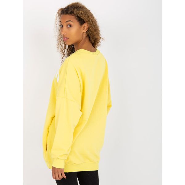 Fashionhunters Yellow loose fit sweatshirt with a print and pockets