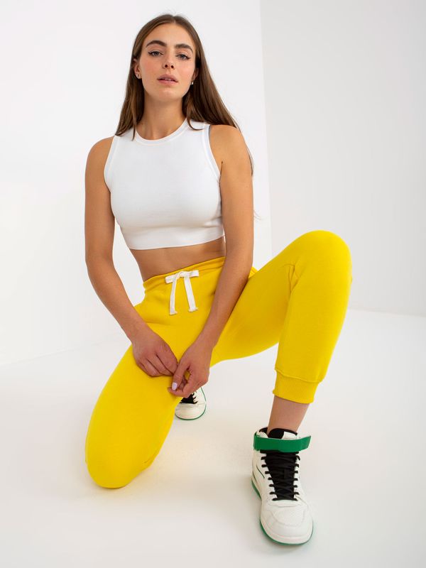 Fashionhunters Yellow smooth jogger pants with tie detail